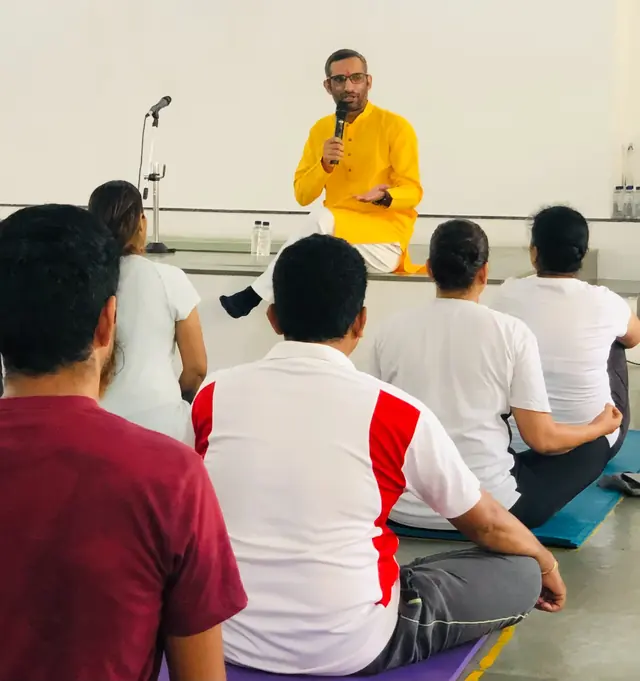 Dr. Somveer Arya teaching a yoga class